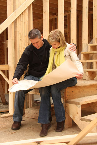 couple reviewing home construction plans